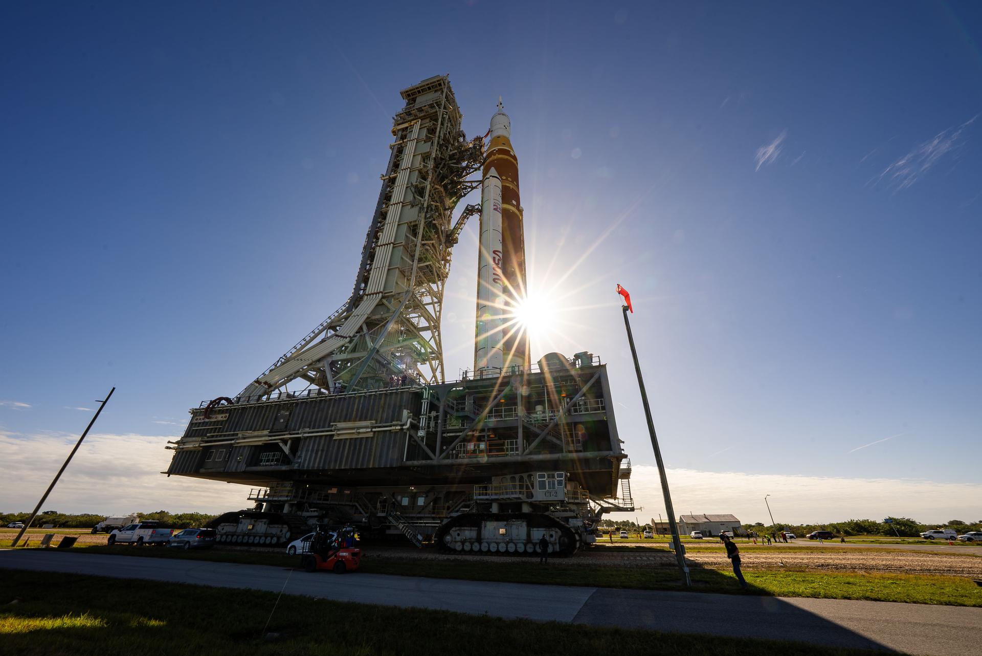 This image shows NASA’s SLS (Space Launch System) and Orion spacecraft rolling out of the Vehicle Assembly Building at NASA’s Kennedy Space Center. NASA's massive Crawler-Transporter, upgraded for the Artemis program, carries the powerful SLS rocket and Orion spacecraft on the Mobile Launcher from the Vehicle Assembly Building to Launch Pad 39B at Kennedy Space Center   in preparation for the Artemis II mission.  